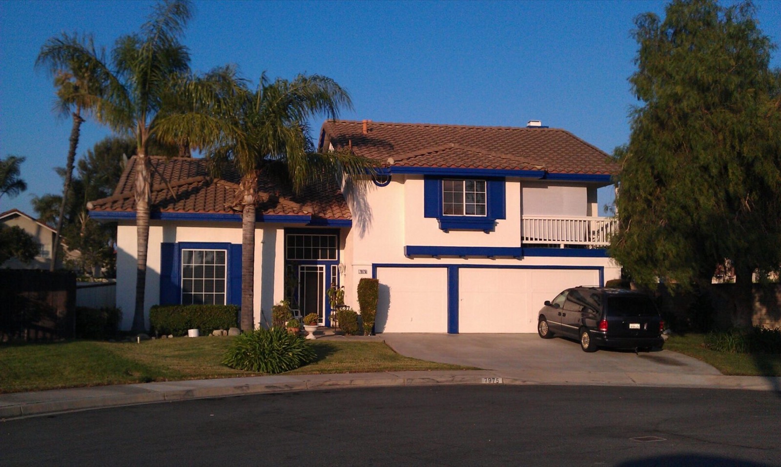 Two-story home with fresh white exterior paint and deep blue trim painted by AAA Painting in Riverside County, CA