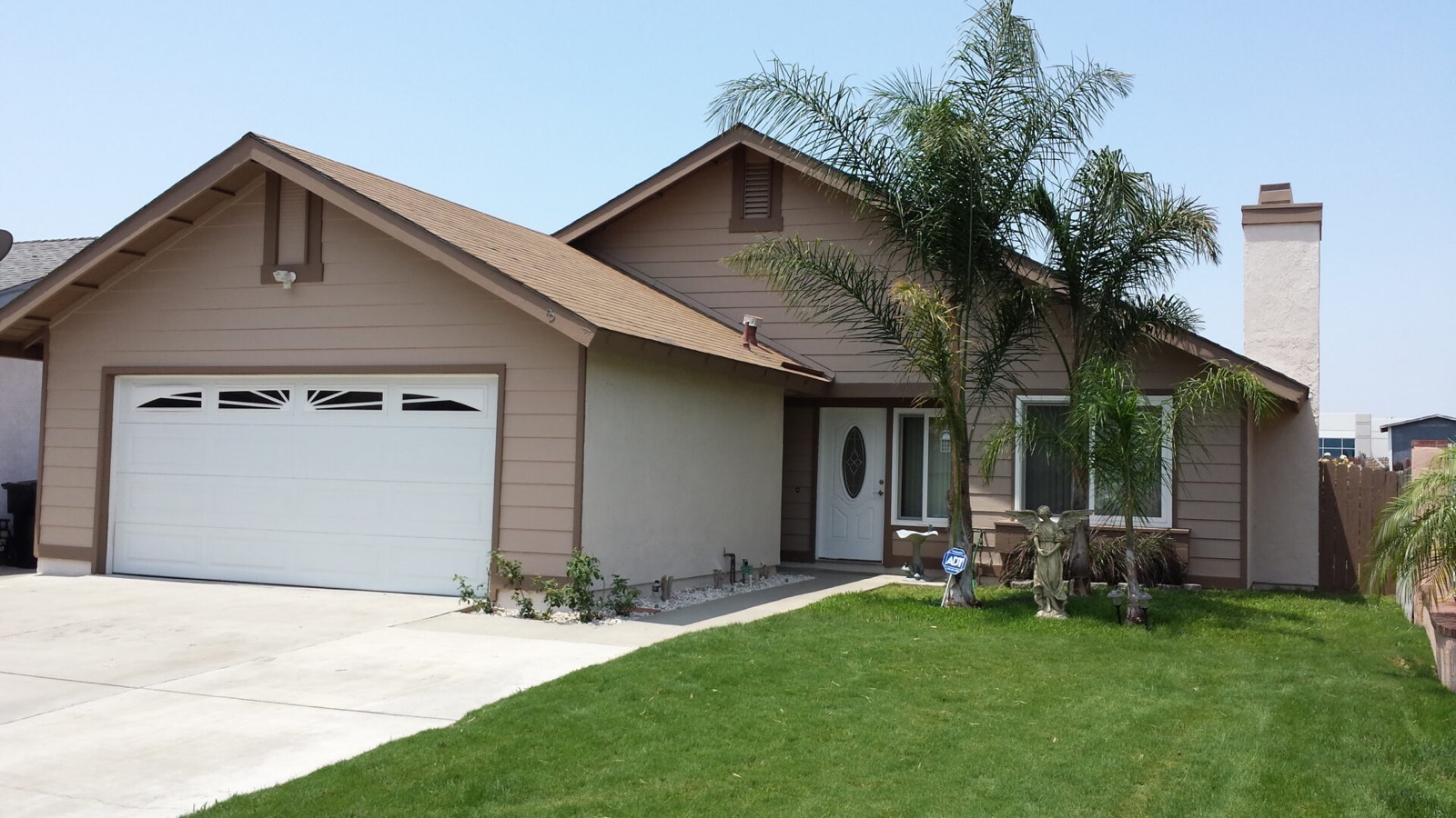 Wood-sided home exterior repainted by AAA Painting in the Inland Empire, CA