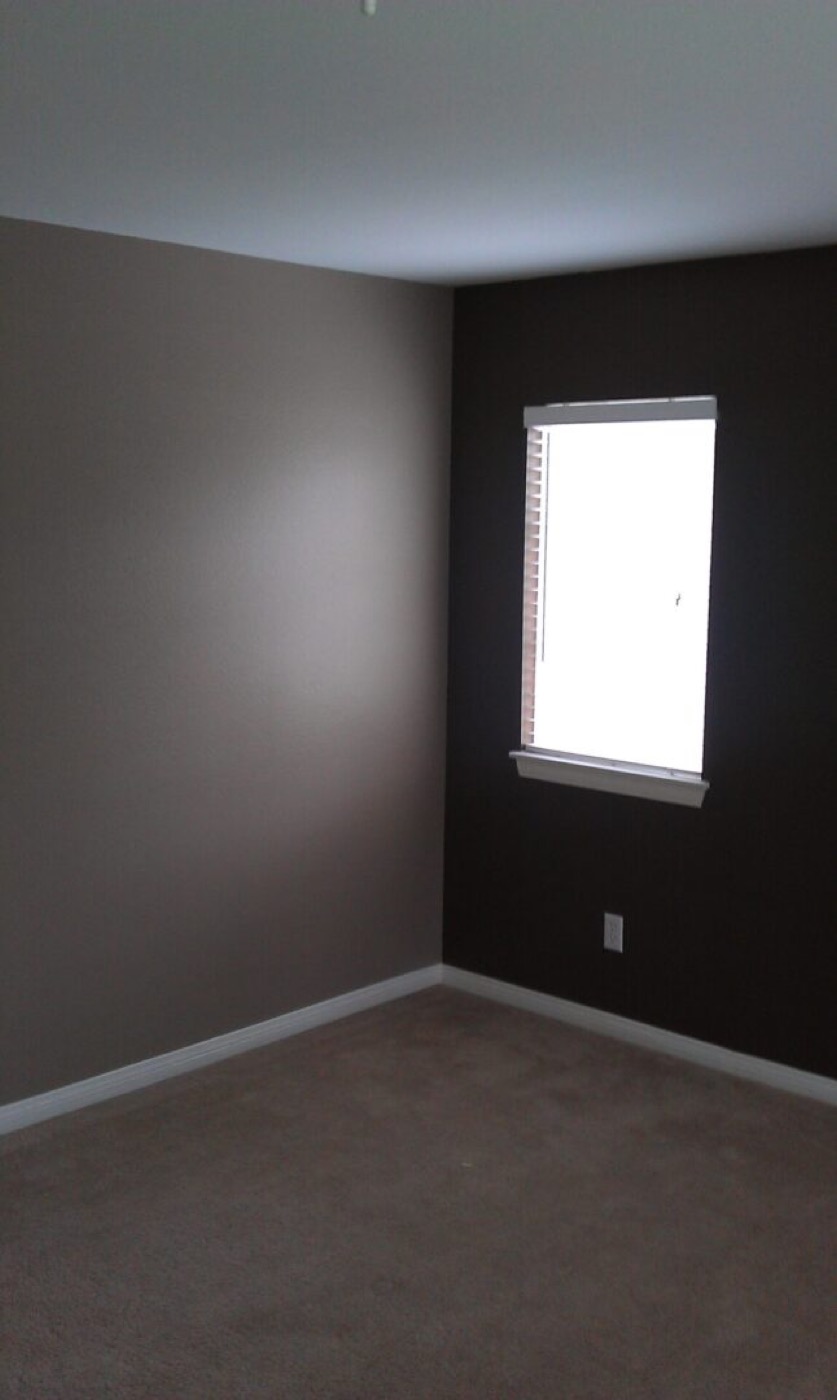 Freshly painted bedroom with dark accent wall by AAA Painting in the Inland Empire, CA